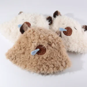 3 colors collection of faux-fur bucket hat featuring a sleeping capybara face with a blue 3D snot bubble and brown ears. Brown, White and Beige.