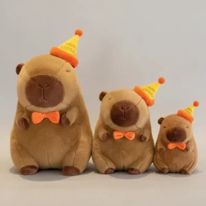 Three fluffy brown capybara plush toys sitting in a row sorted by size, each wearing a yellow "Happy Birthday" party hat and an orange bow tie.