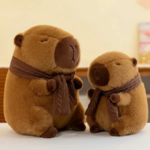 Two fluffy brown capybara plush toys sitting side by side wearing matching brown knitted scarves, featuring closed eyes and a calm expression.