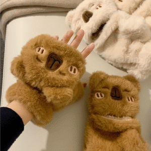 Pair of adult-sized thick faux fur gloves in cream and brown, featuring a convertible fingerless design and an embroidered blushing capybara face on the mitten flap.