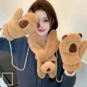 A winter accessory set featuring a plush capybara cross-scarf and matching mittens on a string, shown in soft faux fur material.