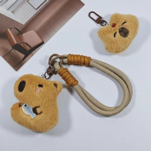 Both styles of capybara phone straps displayed together next to a mobile phone.